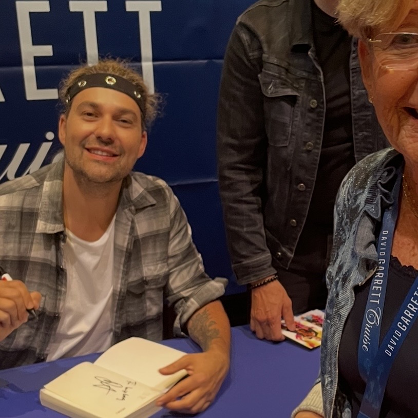David Garrett signing Ingeborg's book on board Mein Schiff 1 · 2 May 2026